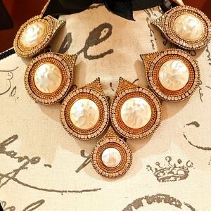 Gold and Cream Bib Necklace with Textured Pendants